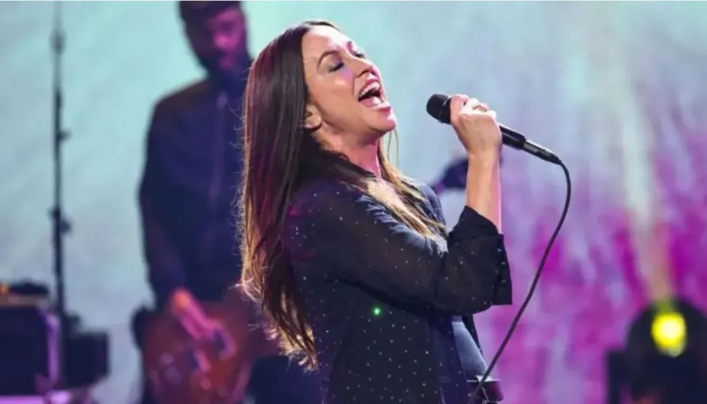 A woman sings into a microphone