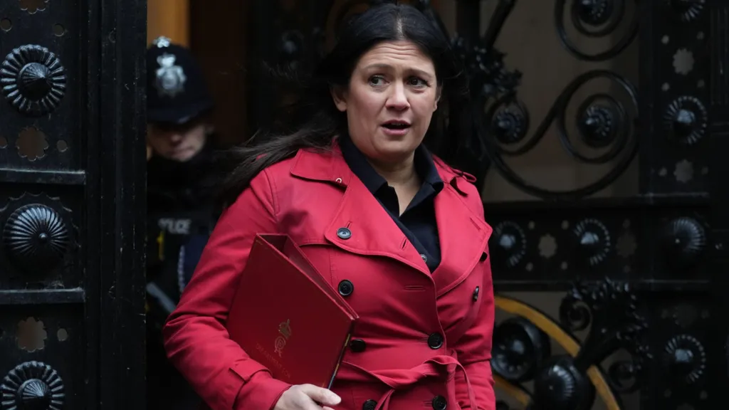 Lisa Nandy wearing a red coat and holding a red folder