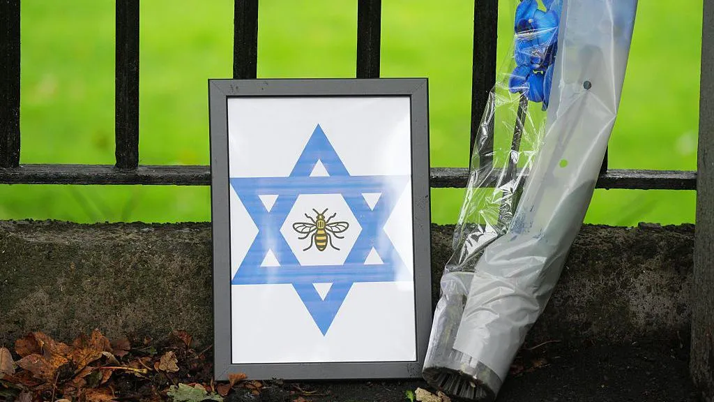 A bunch of flowers and a framed star of David with a bee in the centre, which were left at the scene in tribute after the Manchester synagogue attack
