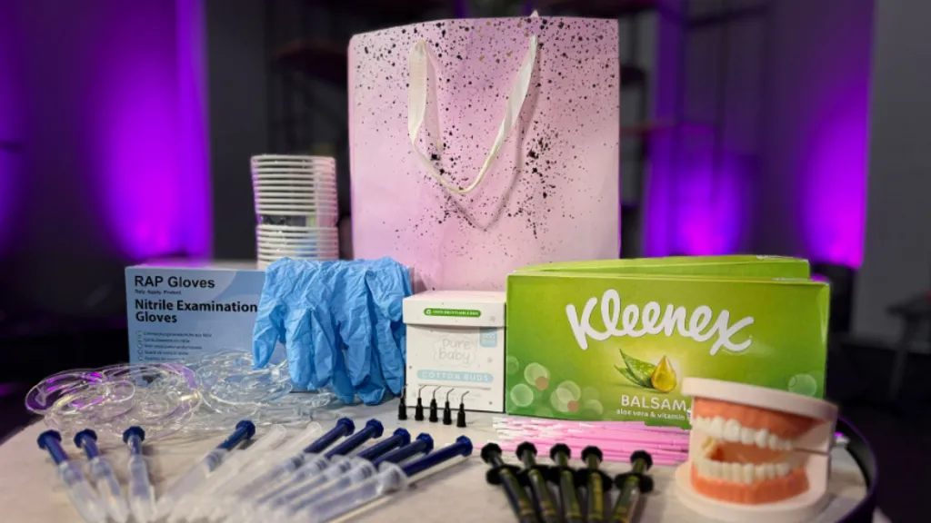 A teeth-whitening kit containing syringes of chemicals, rubber gloves, cotton buds, tissues, a pair of false teeth to practise on, and the pink, sparkly bag in which it all came. 