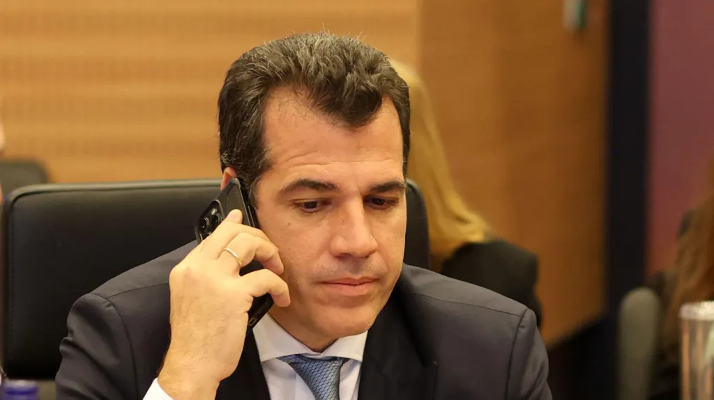Greece's migration and asylum minister Thanos Plevris taking a phone call while seated inside.